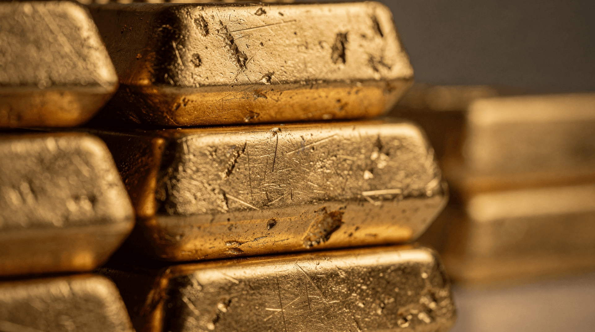 Stacked gold bullion bars in a vault
