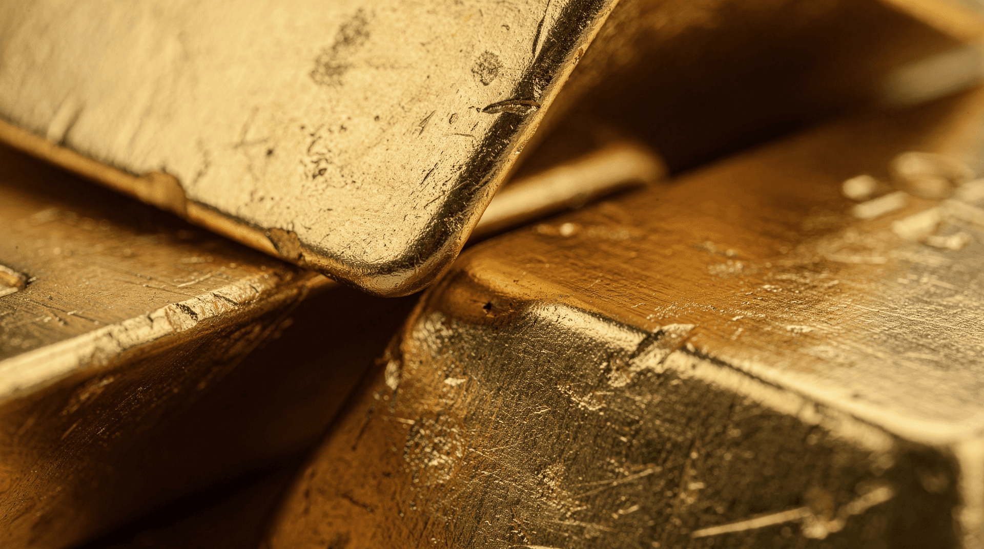 Several gold bars stacked precariously on a dark surface, one slightly toppled, symbolizing falling value.