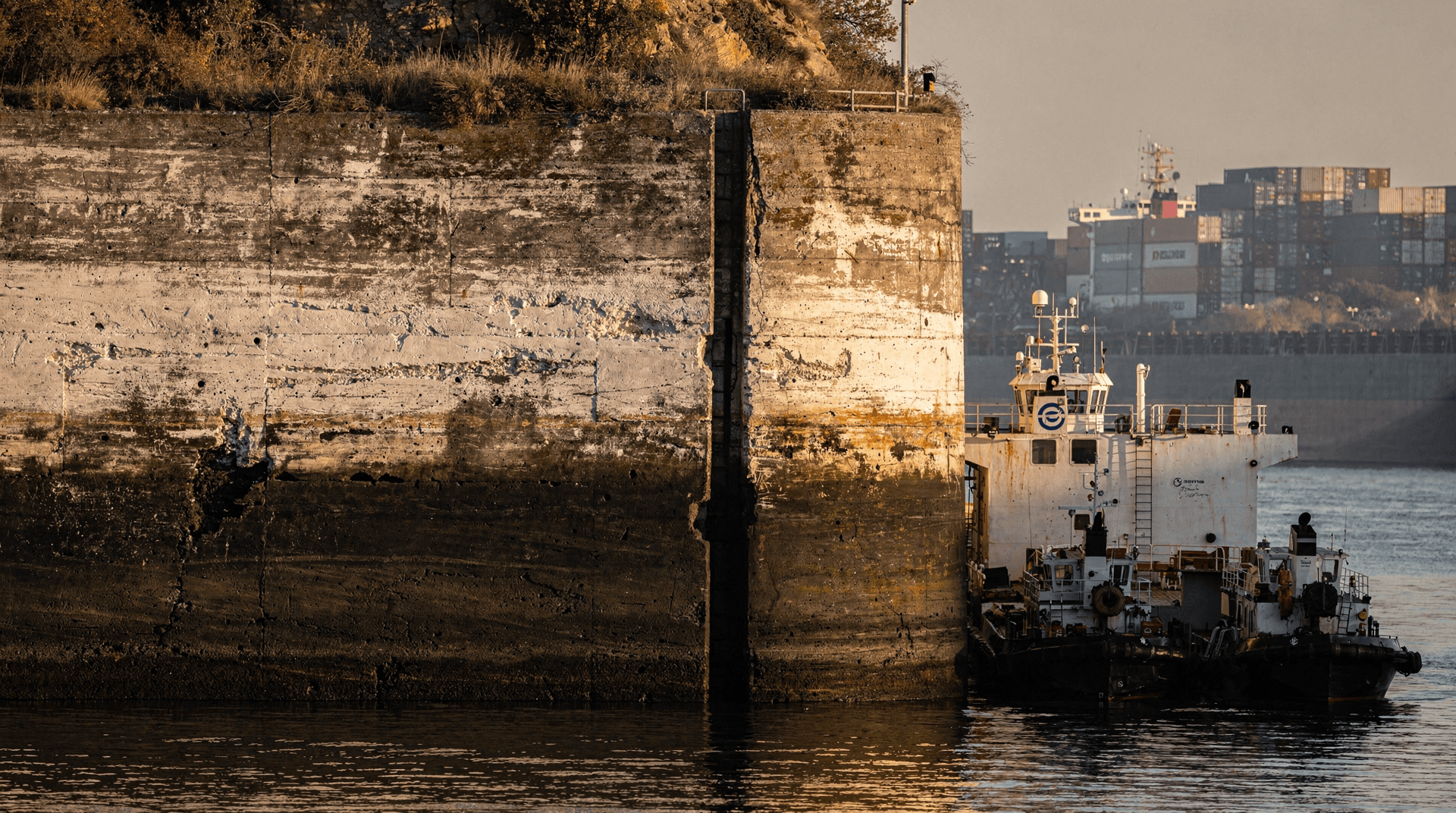 A Panama Canal lock wall showing a dark low-water mark well above the current waterline.