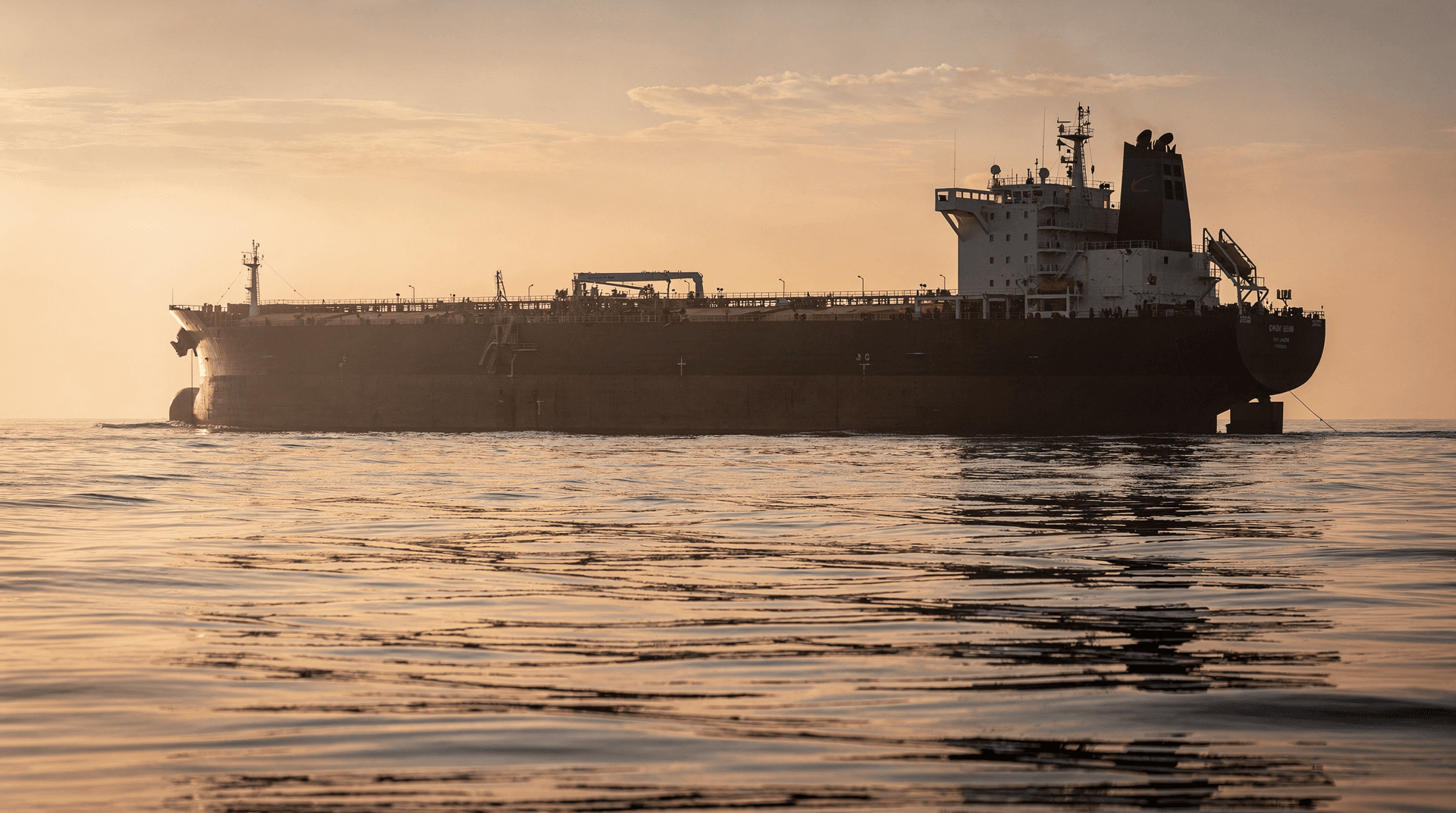 Oil tanker silhouette at sea at dusk