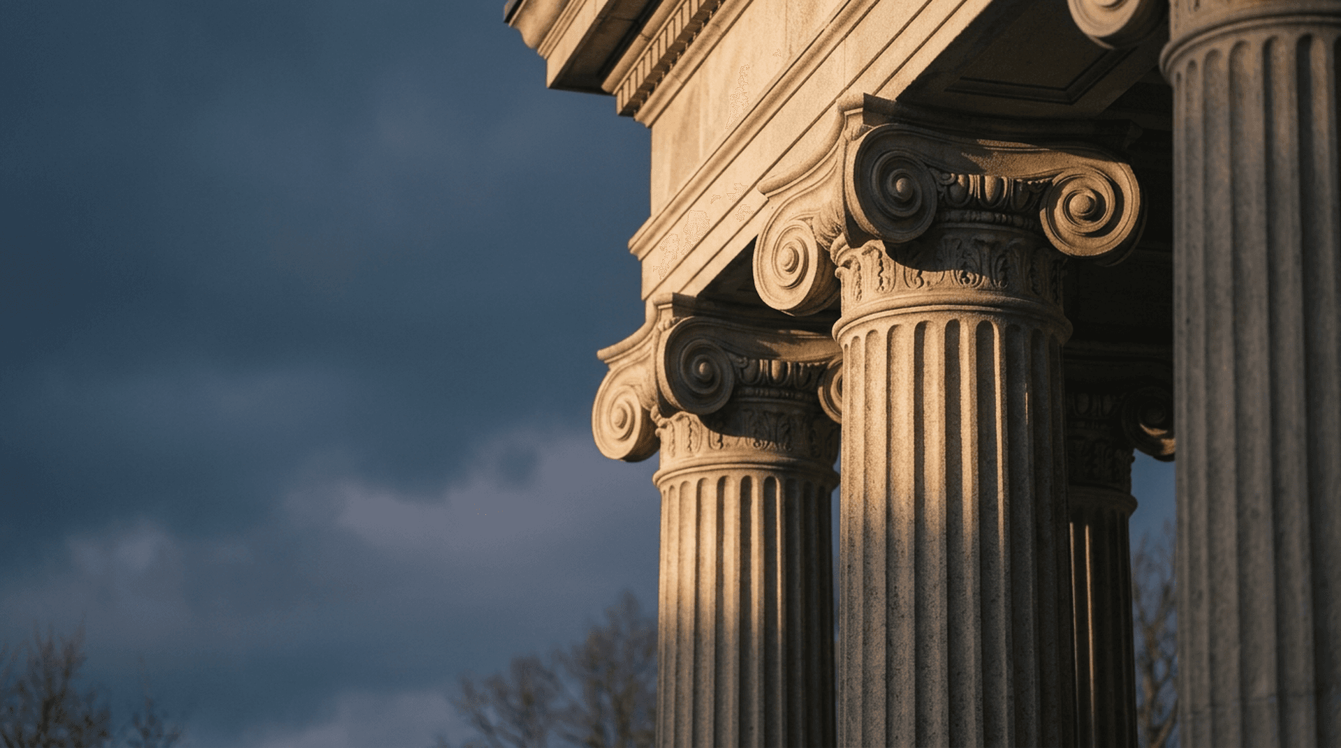Neoclassical government building columns under a darkening dusk sky