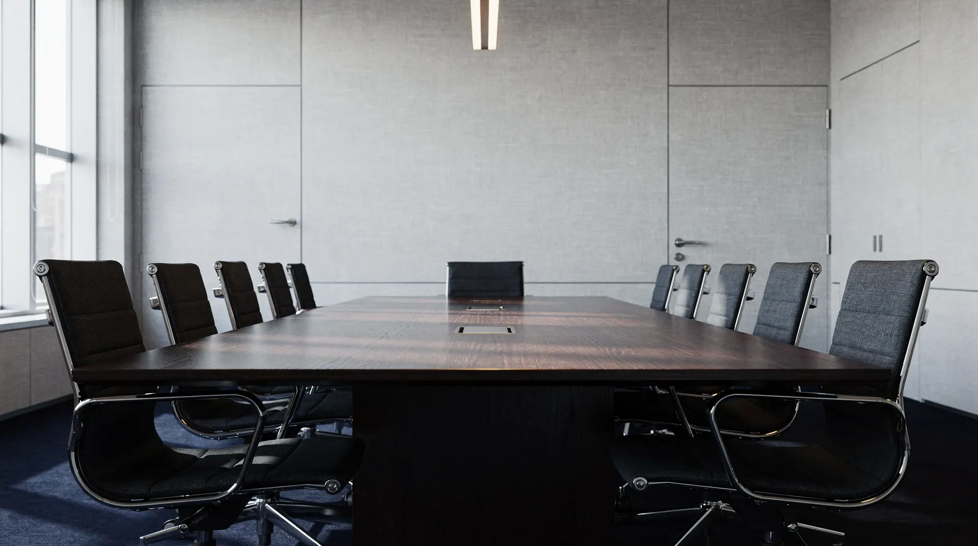 An empty conference table and chairs in a softly lit central-bank meeting room.
