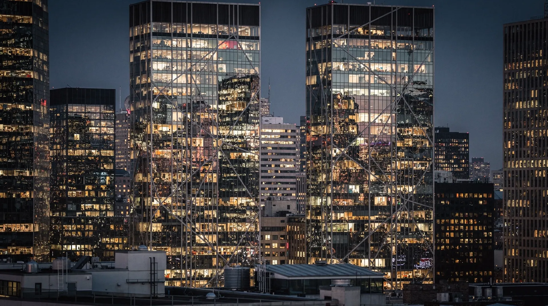 Financial district skyscrapers at dusk with glass curtain-wall reflections