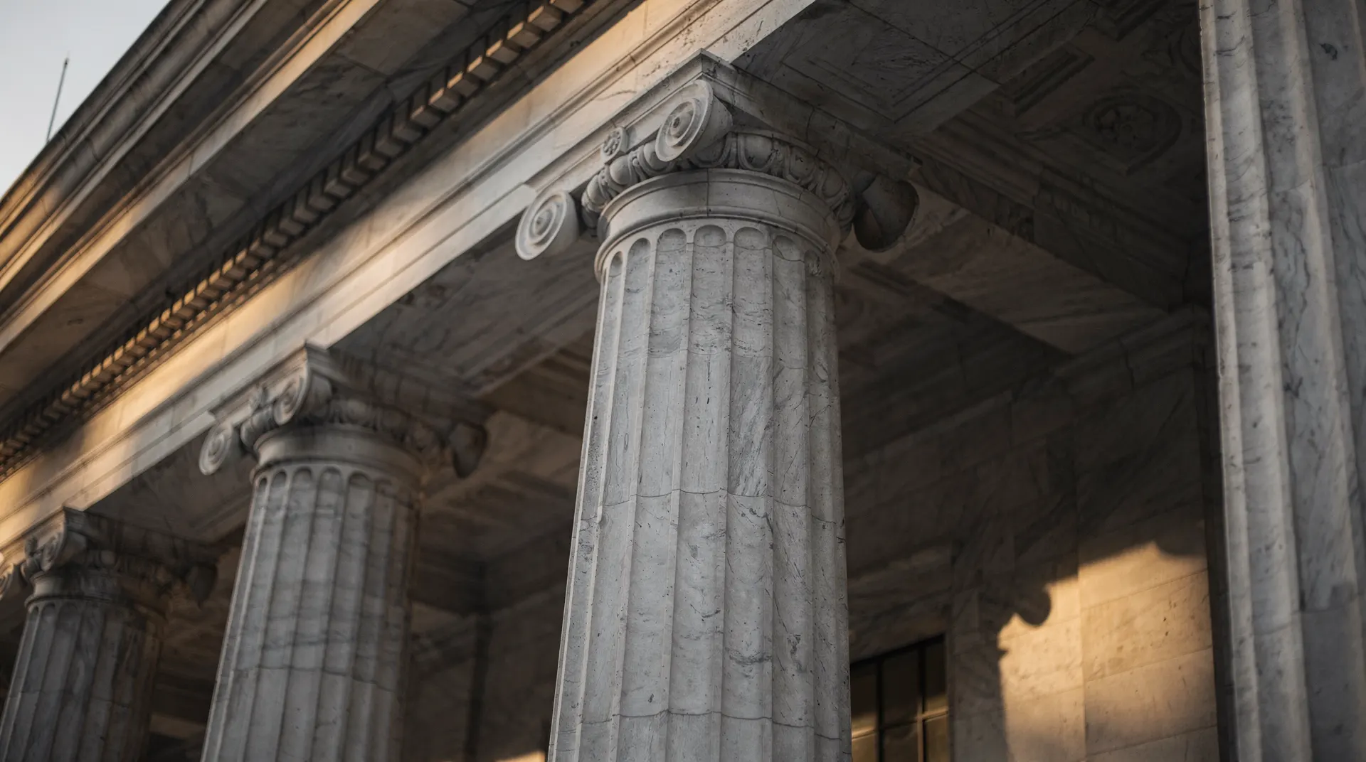 Federal Reserve building exterior with classical marble columns in dramatic light