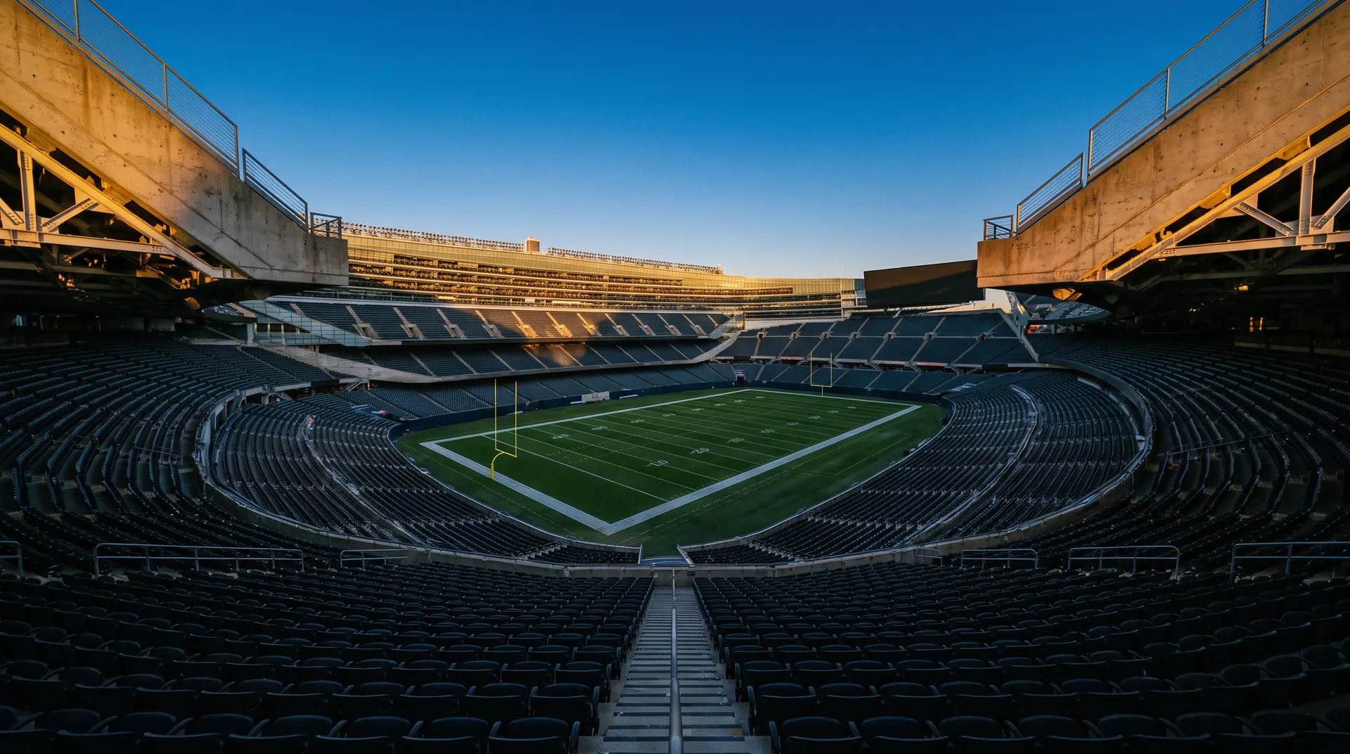 Empty NFL stadium bowl at dusk viewed from upper tier seats